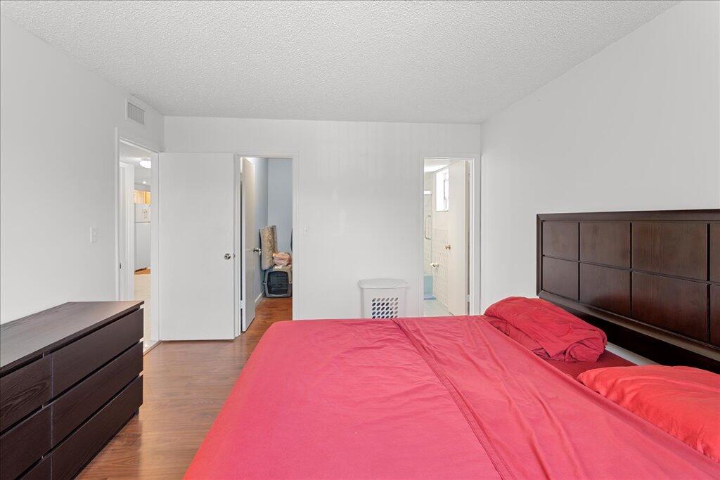 1124 Northwest 13th Street, Unit 120A Boca Raton, FL 33486 - Photo 9 of 23 a bedroom with a bed and a dresser