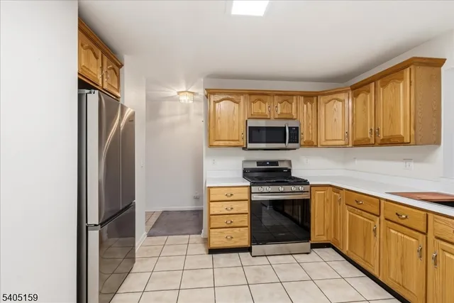 a kitchen with white cabinets stainless steel appliances and a sink