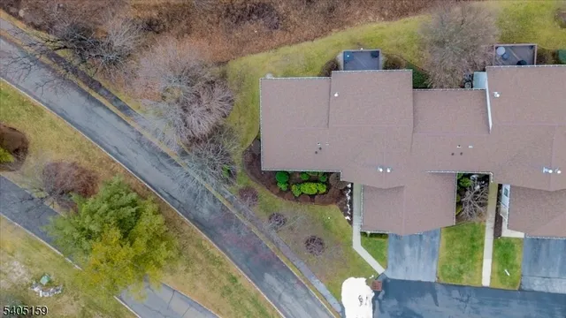 an aerial view of a house with a yard and a large tree