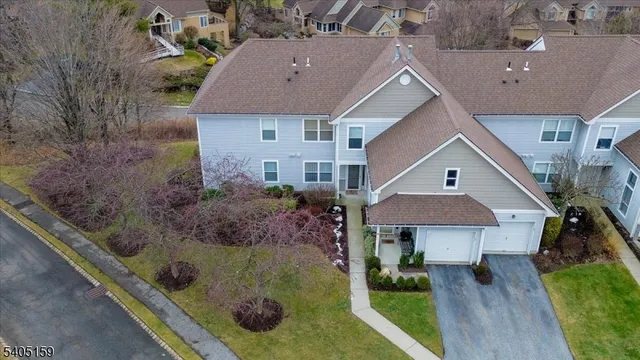 a aerial view of a house next to a yard