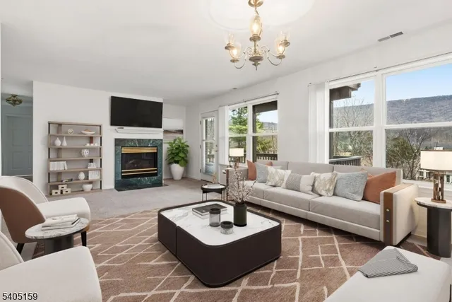 a living room with furniture a fireplace and a flat screen tv