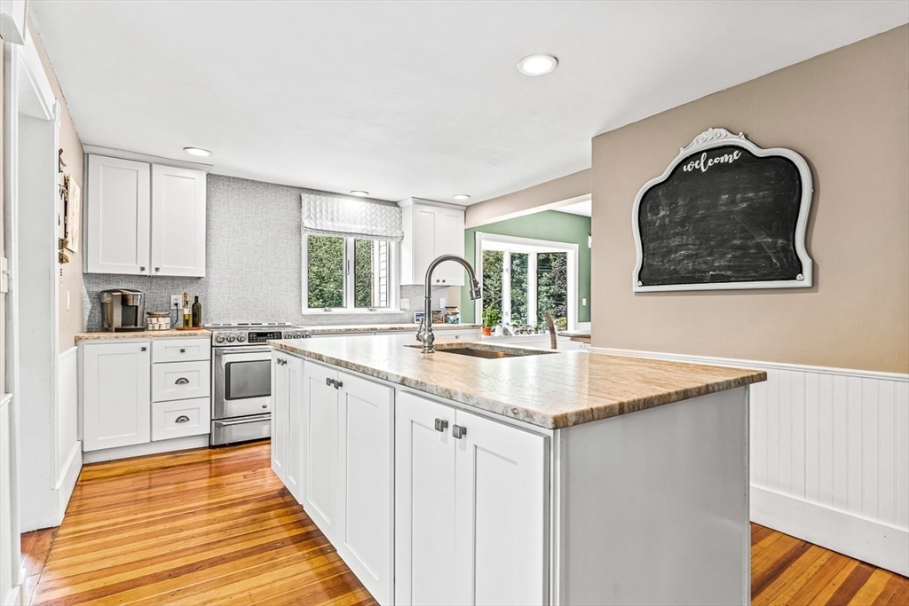 69 Maple Street Middleton, MA 01949 - Photo 12 of 33 a kitchen with white cabinets appliances and a window