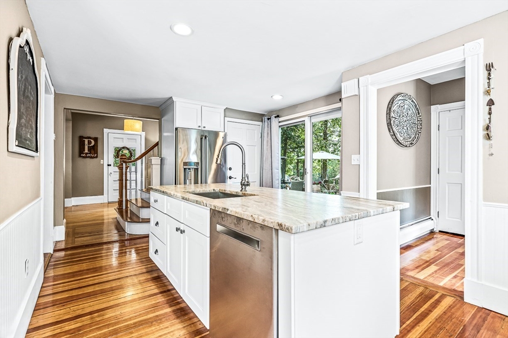 69 Maple Street Middleton, MA 01949 - Photo 13 of 33 a spacious bathroom with a granite countertop sink and a large mirror