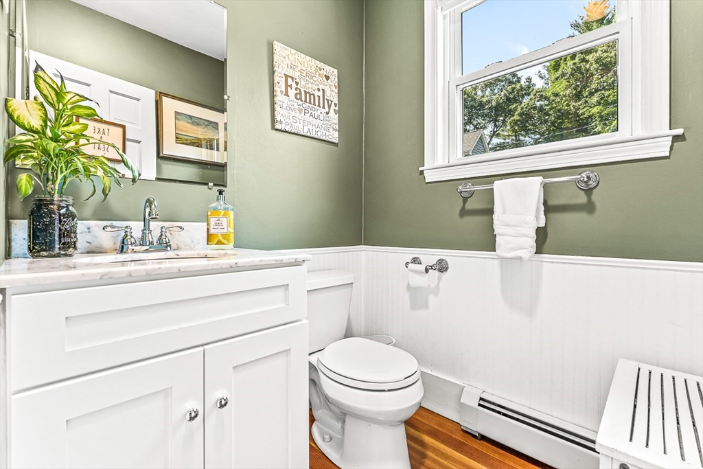 69 Maple Street Middleton, MA 01949 - Photo 16 of 33 a bathroom with a toilet sink and mirror