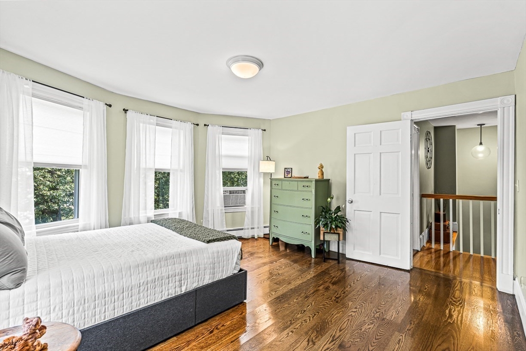 69 Maple Street Middleton, MA 01949 - Photo 19 of 33 a spacious bedroom with a bed and wooden floor