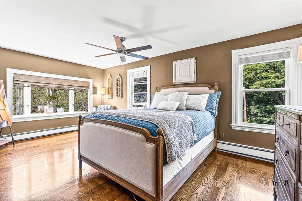 69 Maple Street Middleton, MA 01949 - Photo 21 of 33 a spacious bedroom with a large bed and a large window with the outer view