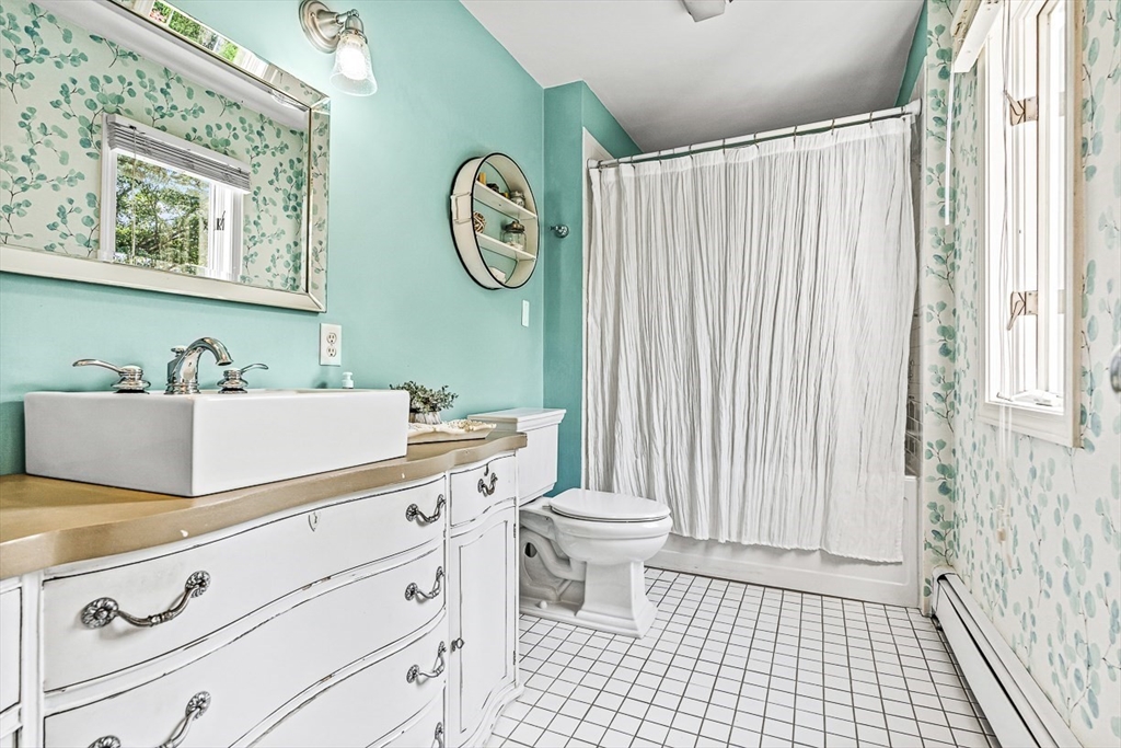 69 Maple Street Middleton, MA 01949 - Photo 23 of 33 a bathroom with a sink a toilet and a shower curtain