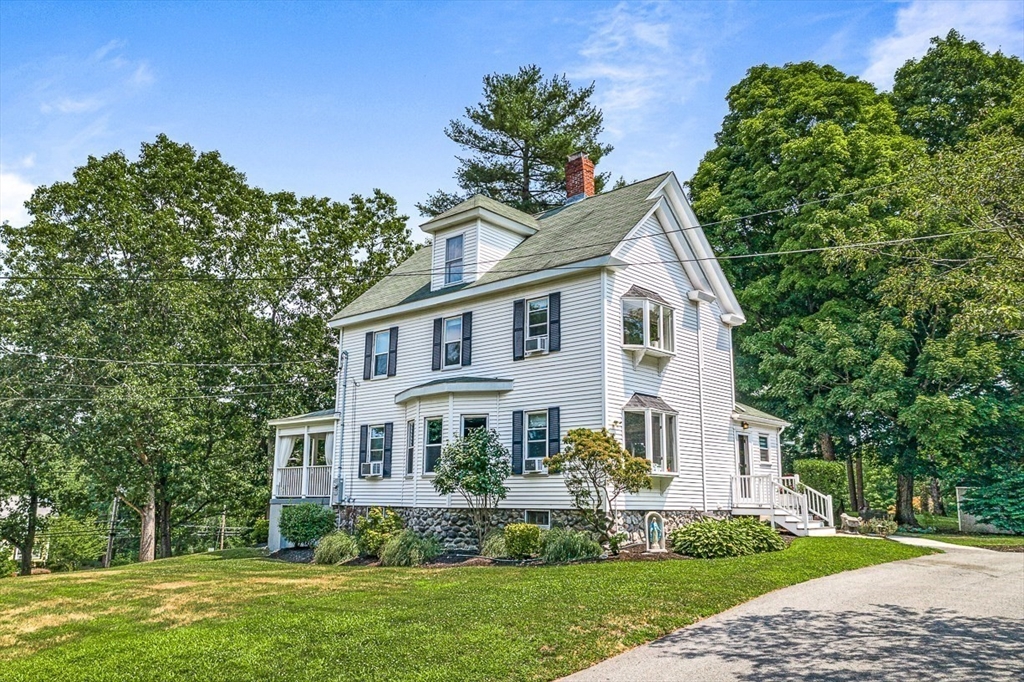 69 Maple Street Middleton, MA 01949 - Photo 3 of 33 a front view of a house with a garden
