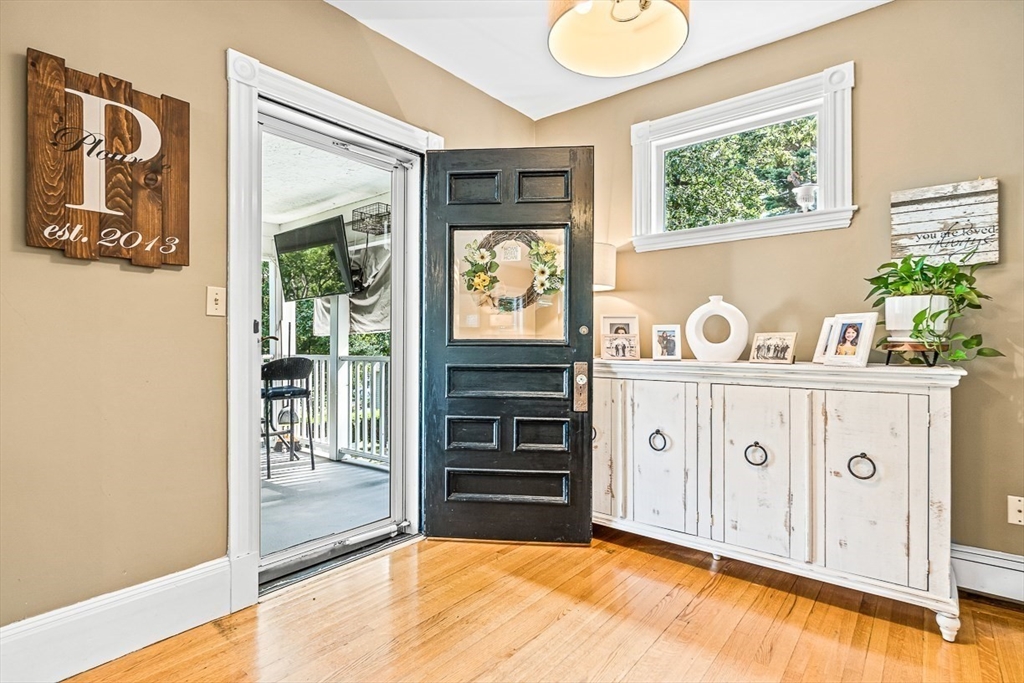 69 Maple Street Middleton, MA 01949 - Photo 4 of 33 a view of a hallway with entryway wooden floor and front door