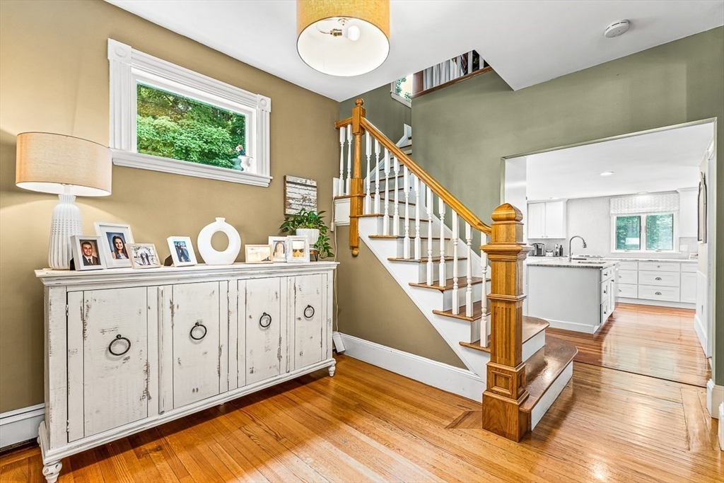 69 Maple Street Middleton, MA 01949 - Photo 5 of 33 a view of a hallway with wooden floor and entryway
