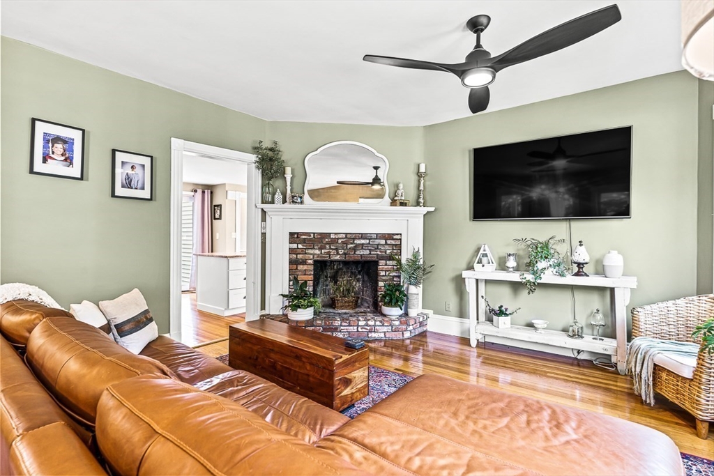 69 Maple Street Middleton, MA 01949 - Photo 10 of 33 a living room with furniture a flat screen tv and a fireplace