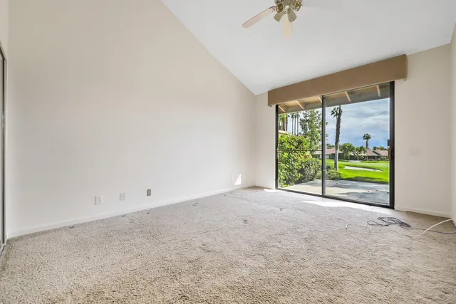 an empty room with a window and fireplace