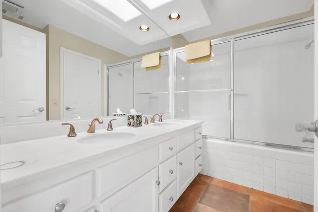 a view of a house with a yard and potted plants