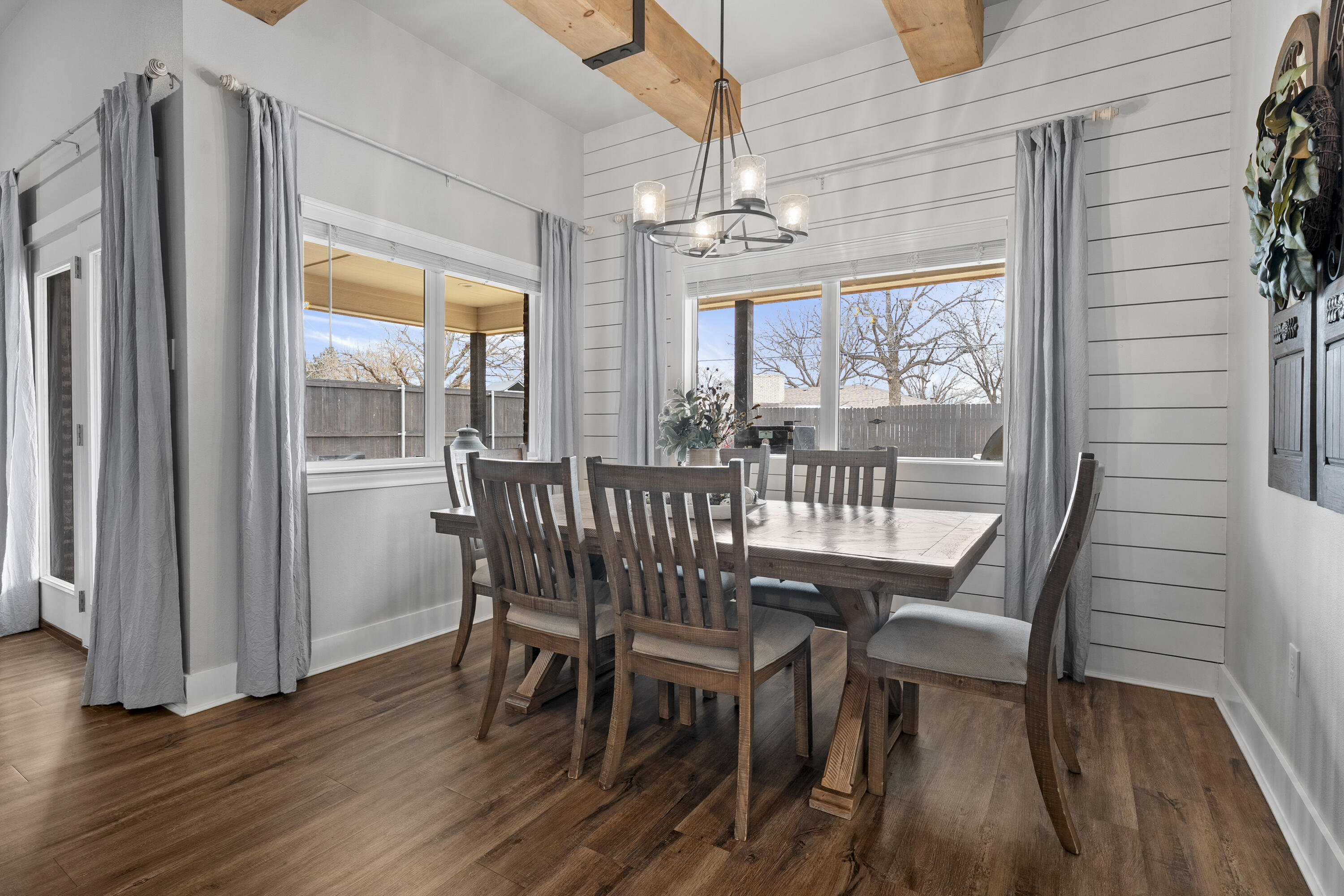 1122 16th Street Shallowater, TX 79363 - Photo 11 of 32 a view of a dining room with furniture wooden floor and chandelier