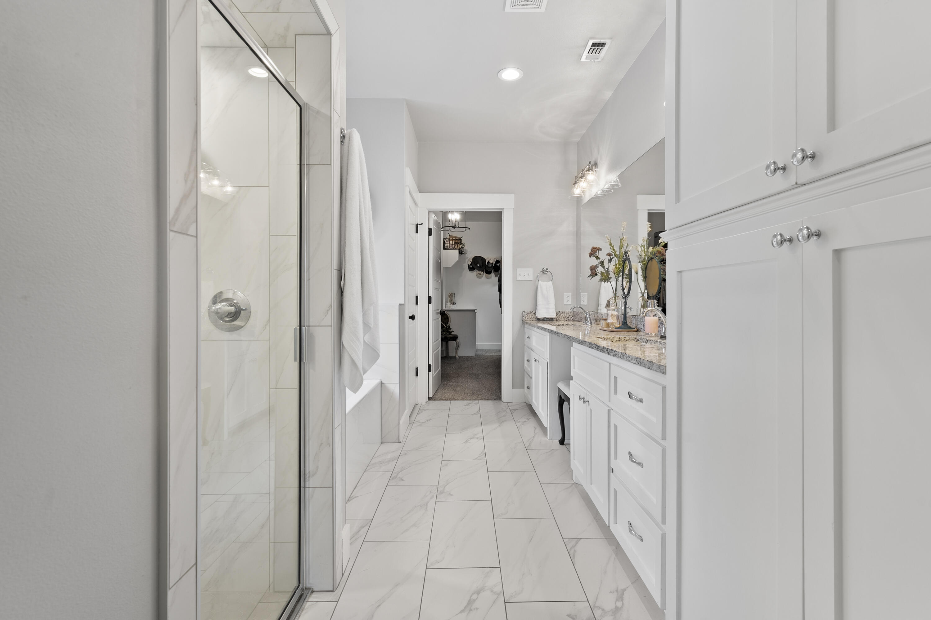 1122 16th Street Shallowater, TX 79363 - Photo 15 of 32 a bathroom with a double vanity sink and a shower
