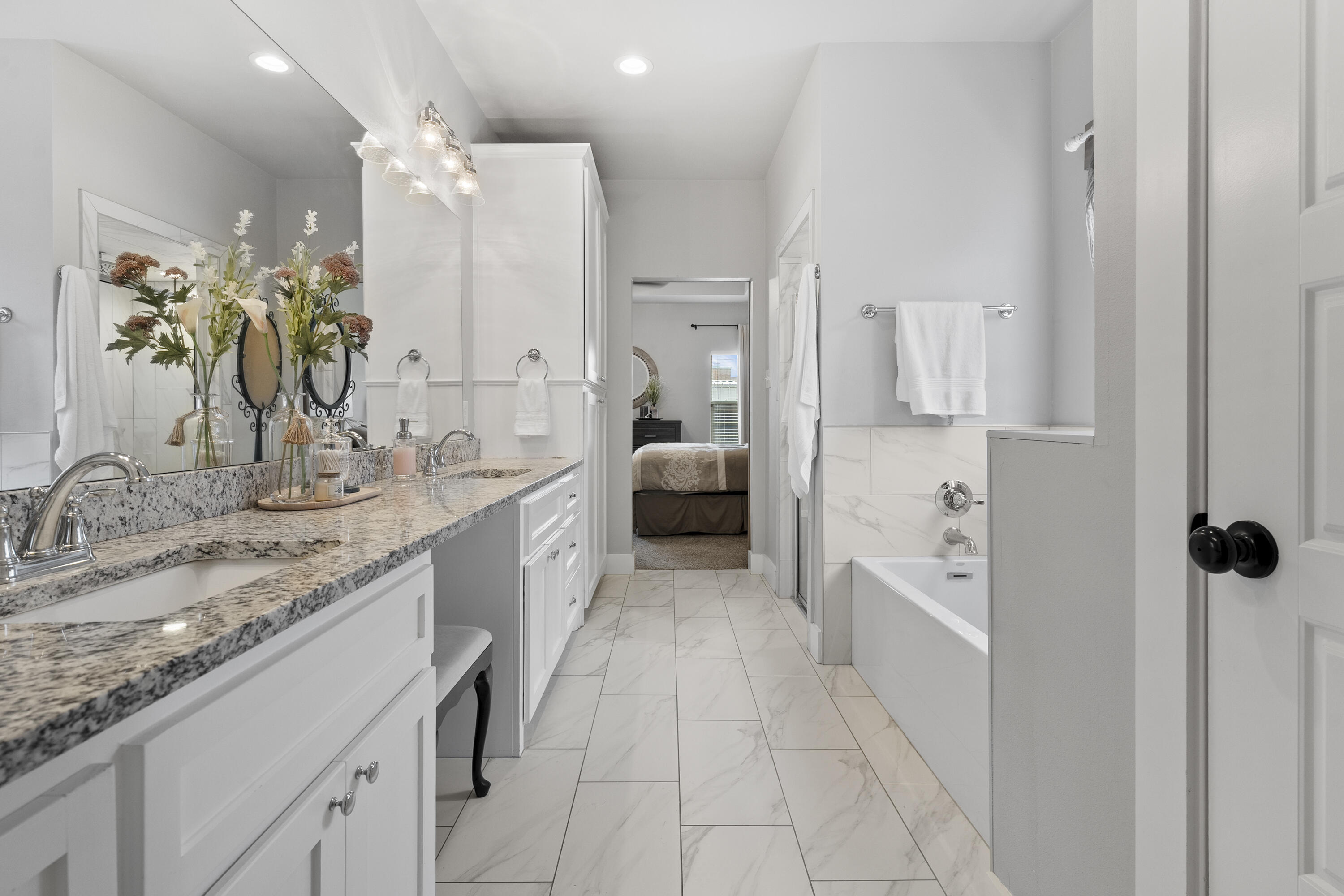 1122 16th Street Shallowater, TX 79363 - Photo 16 of 32 a bathroom with a double vanity sink a mirror and a shower