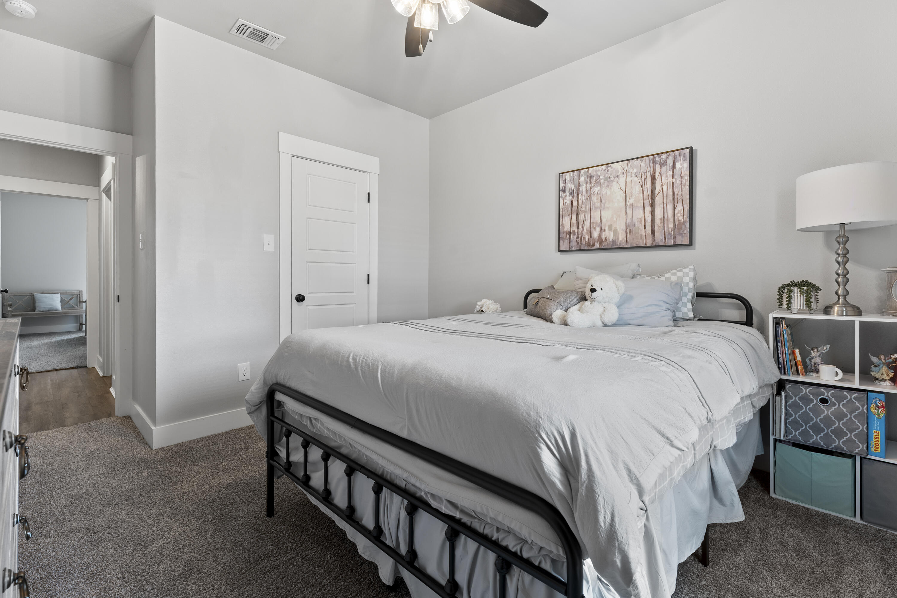 1122 16th Street Shallowater, TX 79363 - Photo 23 of 32 a bedroom with a bed and a chandelier
