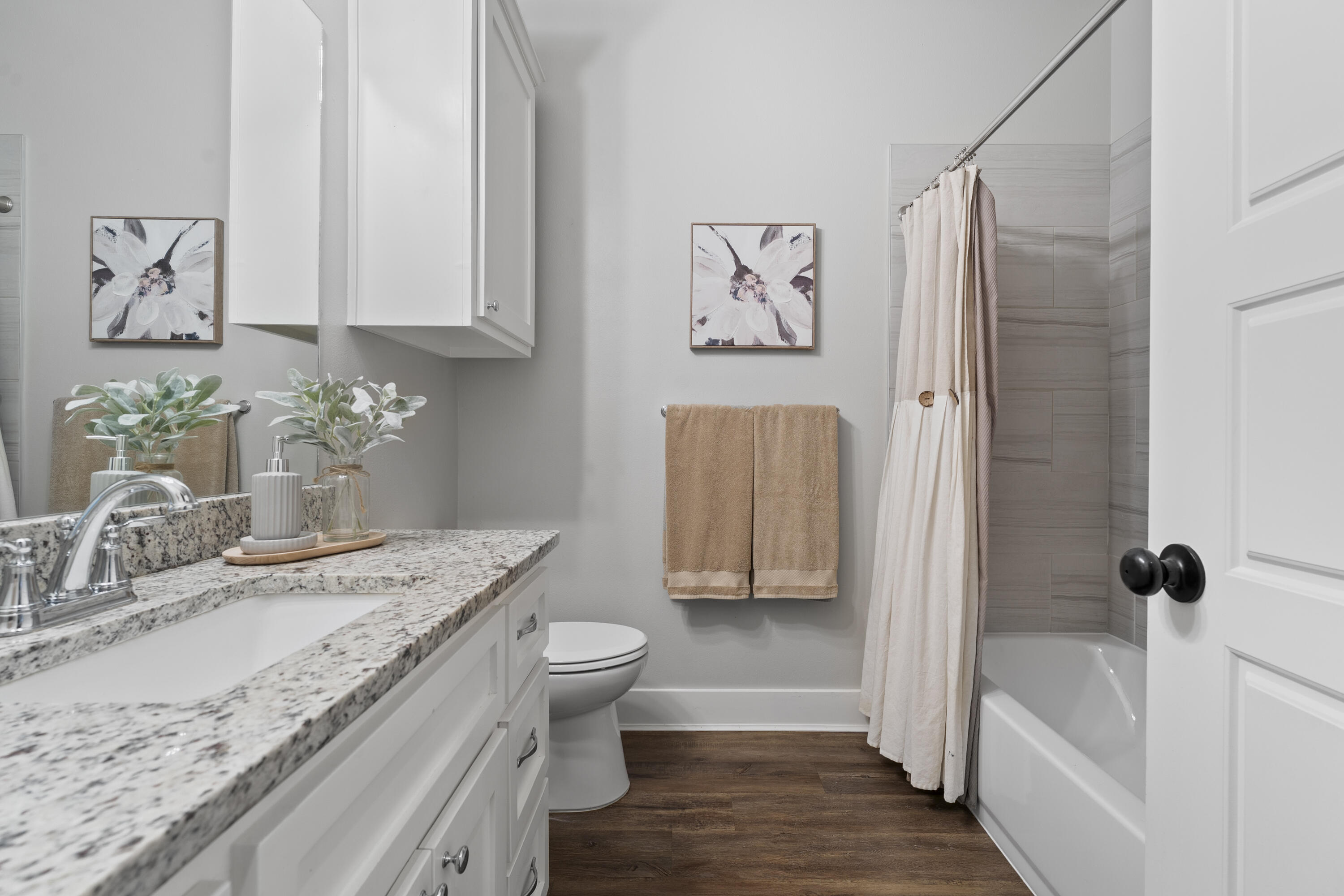 1122 16th Street Shallowater, TX 79363 - Photo 25 of 32 a bathroom with a granite countertop sink a toilet and bathtub