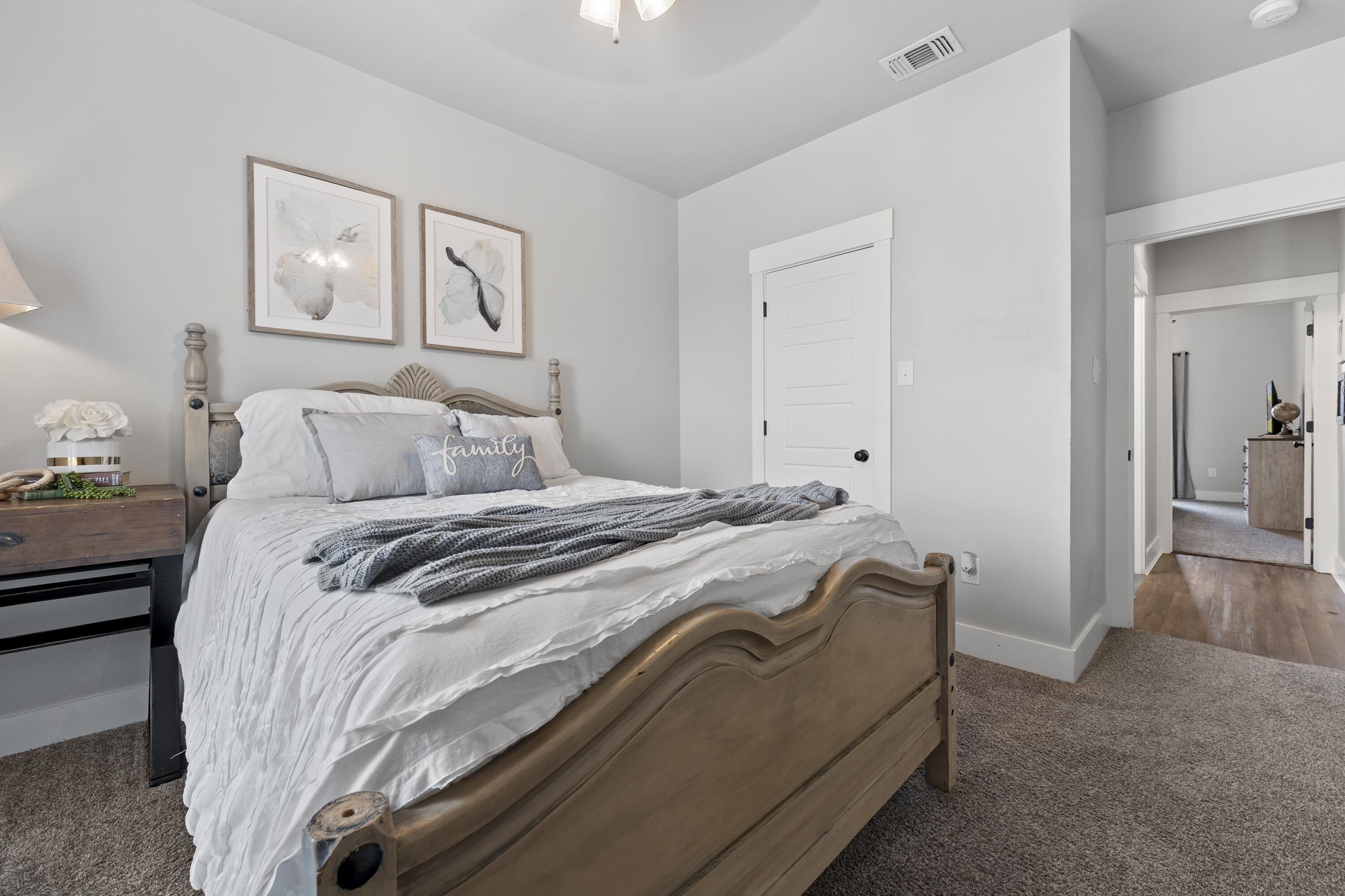 1122 16th Street Shallowater, TX 79363 - Photo 26 of 32 a bedroom with a bed and a painting on the wall