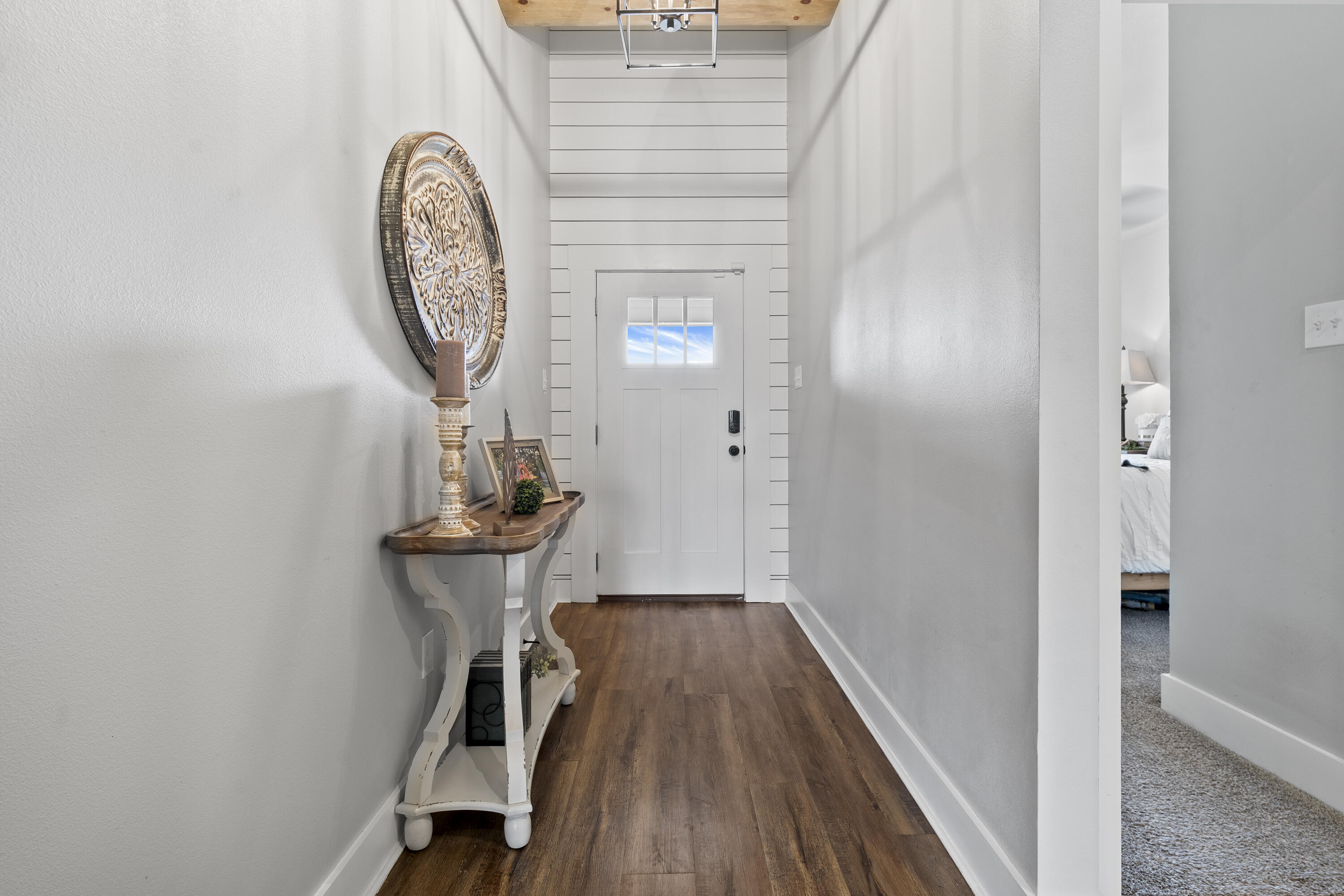 1122 16th Street Shallowater, TX 79363 - Photo 3 of 32 a view of a hallway with wooden floor