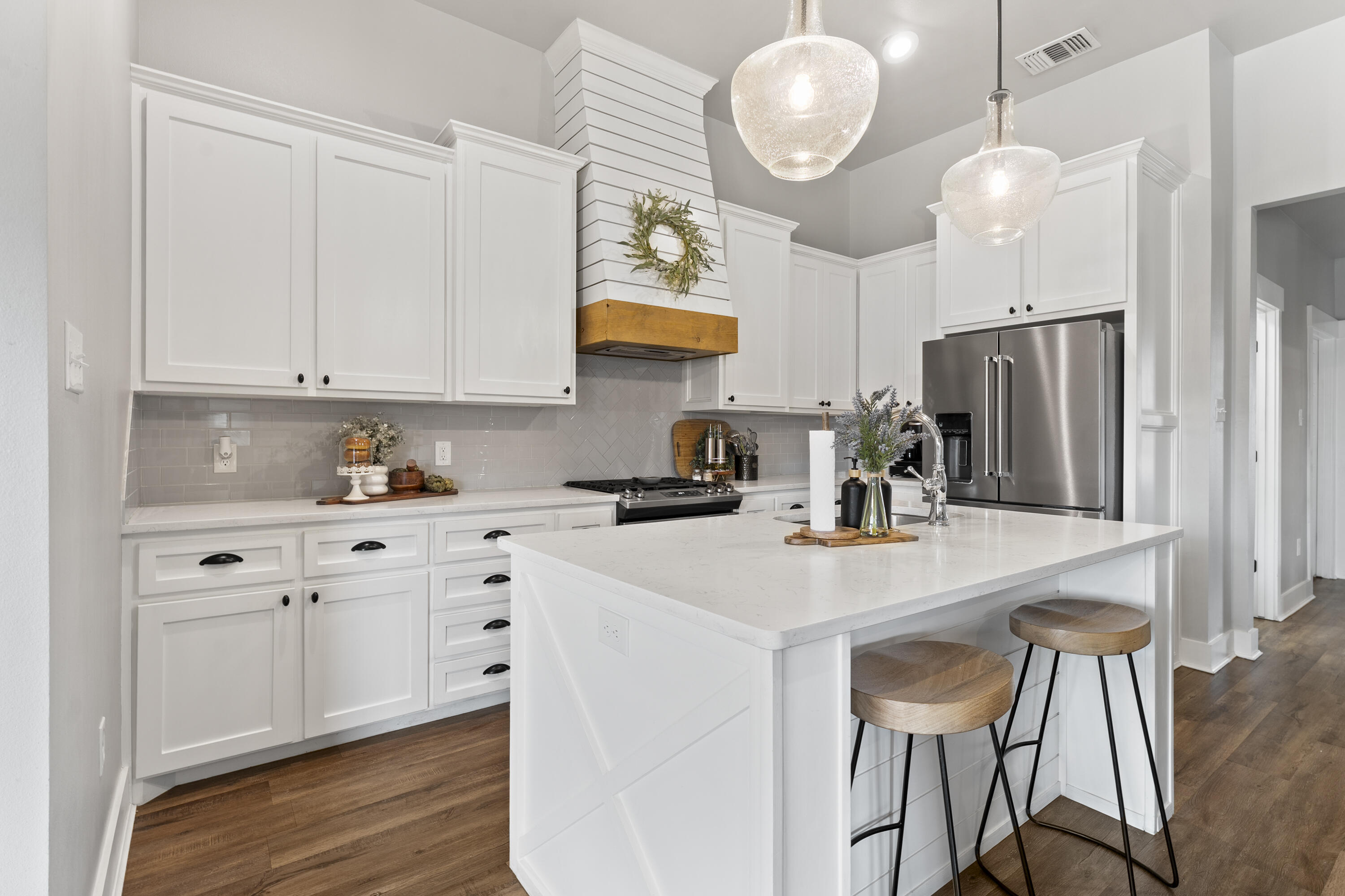 1122 16th Street Shallowater, TX 79363 - Photo 8 of 32 a kitchen with cabinets a sink stainless steel appliances and dining table
