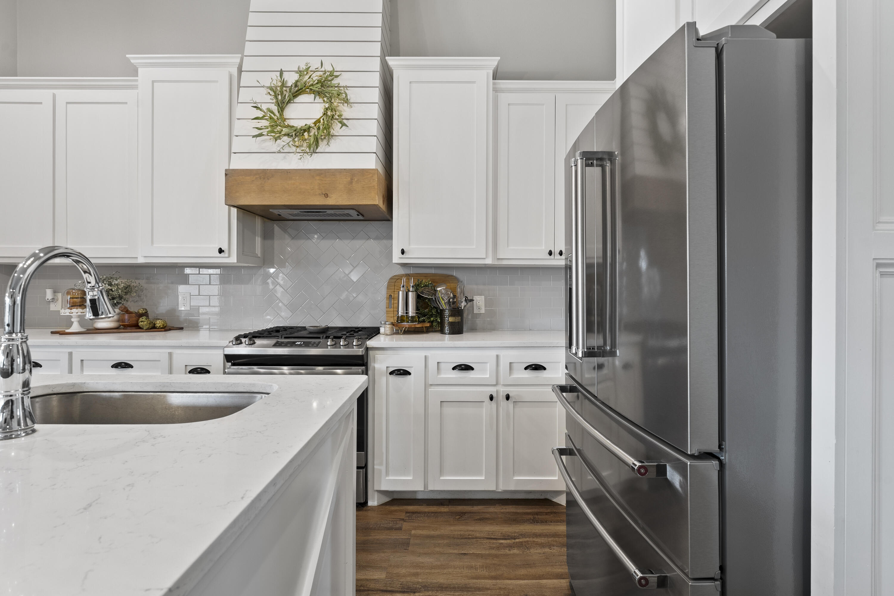 1122 16th Street Shallowater, TX 79363 - Photo 9 of 32 a kitchen with stainless steel appliances granite countertop a refrigerator sink and stove
