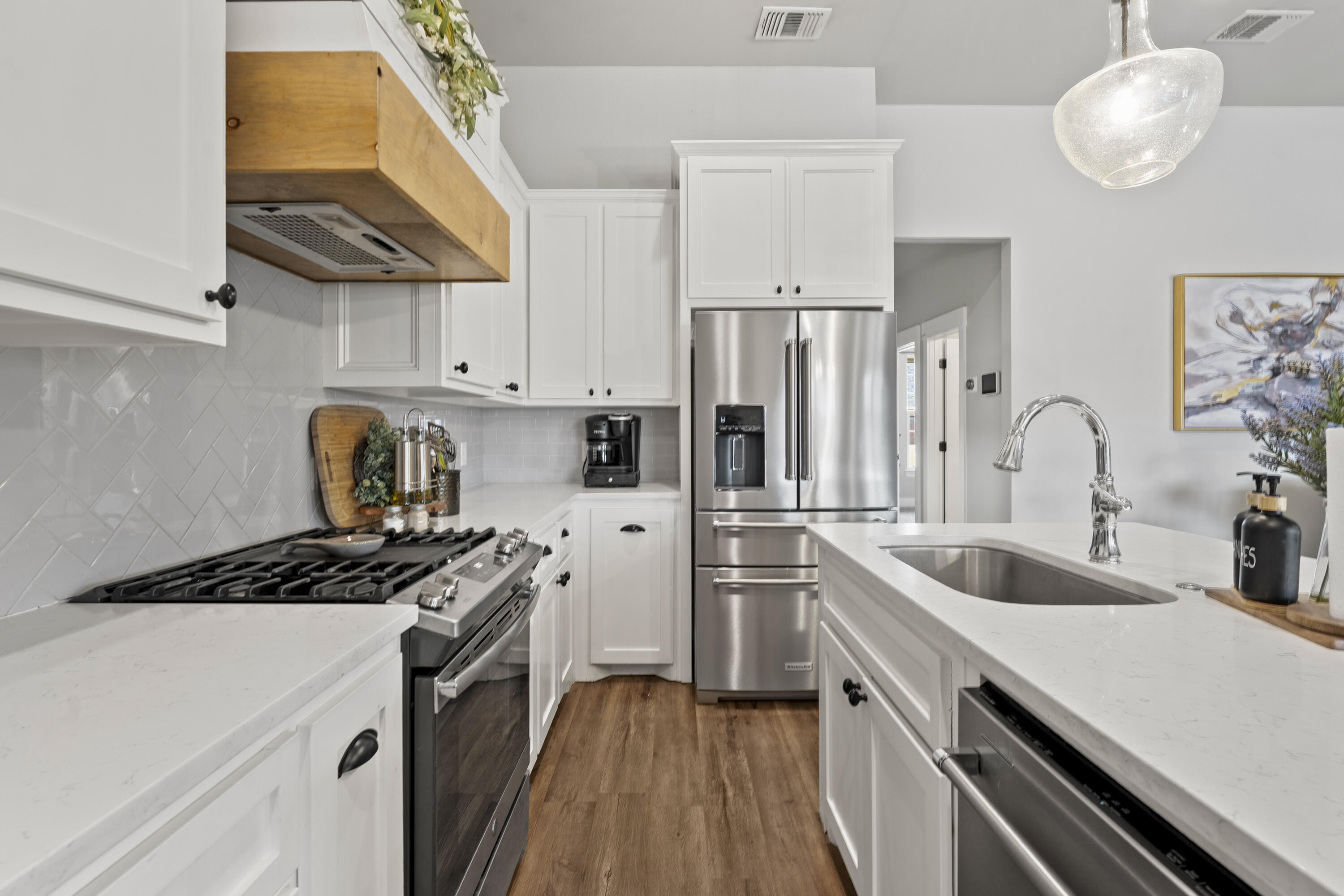 1122 16th Street Shallowater, TX 79363 - Photo 10 of 32 a kitchen with stainless steel appliances a sink dishwasher stove refrigerator and cabinets