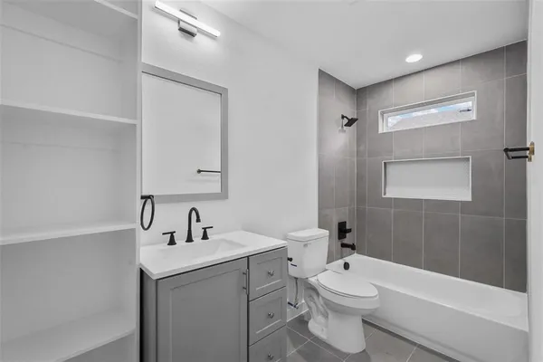 a bathroom with a toilet a sink and bathtub