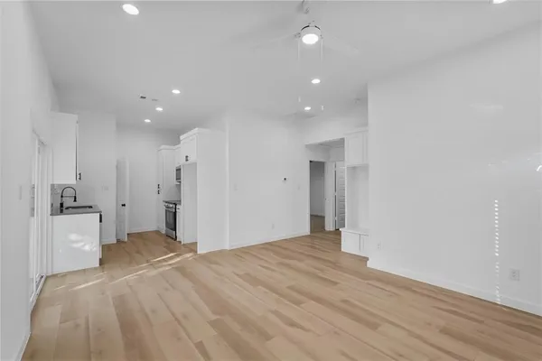 a view of a kitchen with a refrigerator and a sink