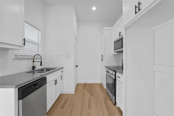 a kitchen with a sink stove and refrigerator