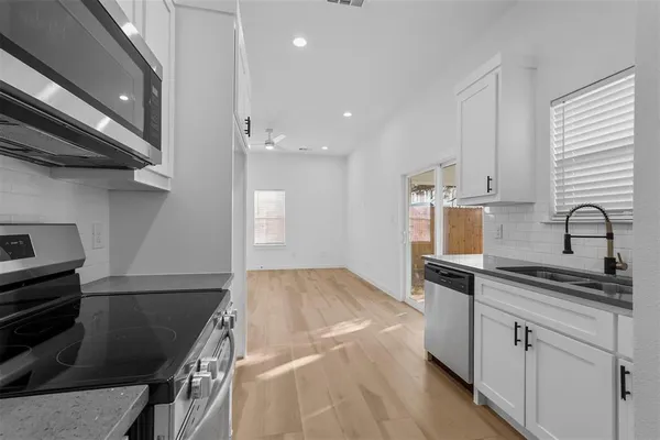 a kitchen with a sink and cabinets