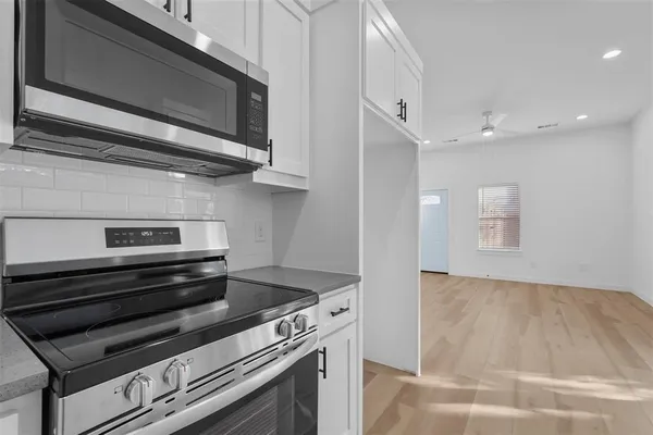 a stove top oven sitting inside of a kitchen