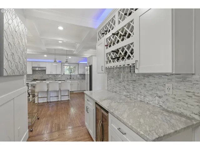 a kitchen with stainless steel appliances kitchen island granite countertop a sink and cabinets
