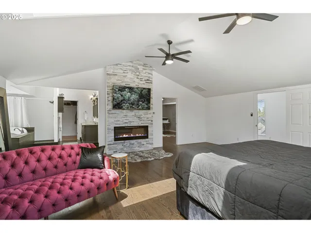 a bedroom with a large bed and a fireplace