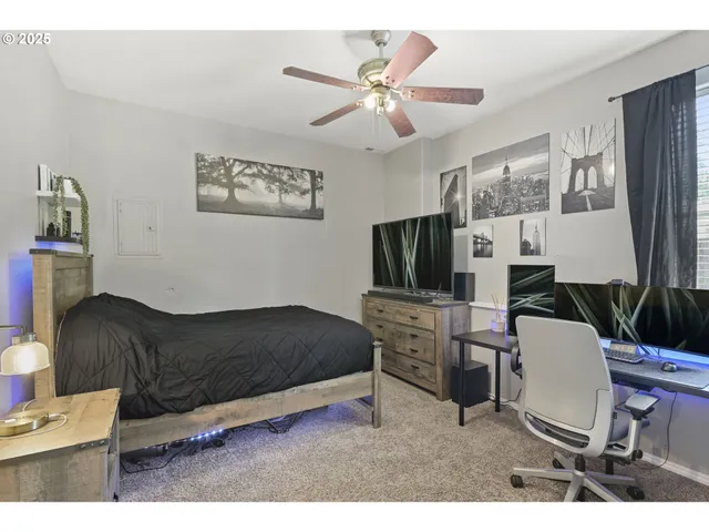 a living room with furniture a flat screen tv and a window