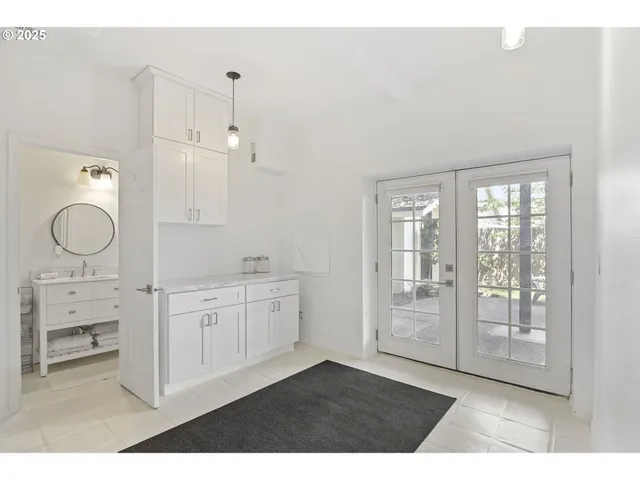 a spacious bathroom with double vanity and a mirror