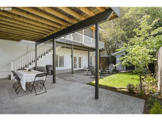 a view of a house with backyard and sitting area