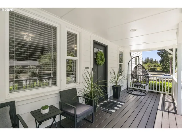 a view of a balcony with chairs and wooden floor