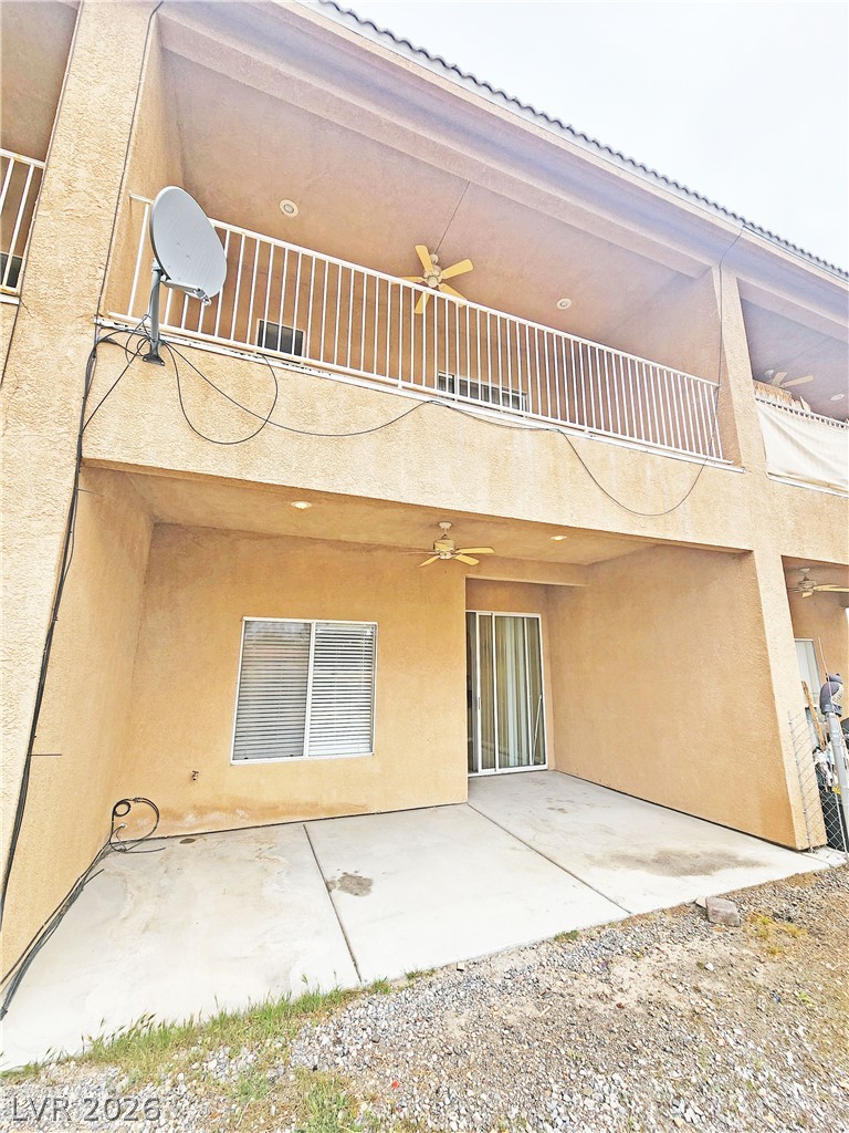 1421 Star Road, Unit 2 Pahrump, NV 89048 - Photo 30 of 33 Back of house with a ceiling fan, a patio, stucco siding, and a balcony