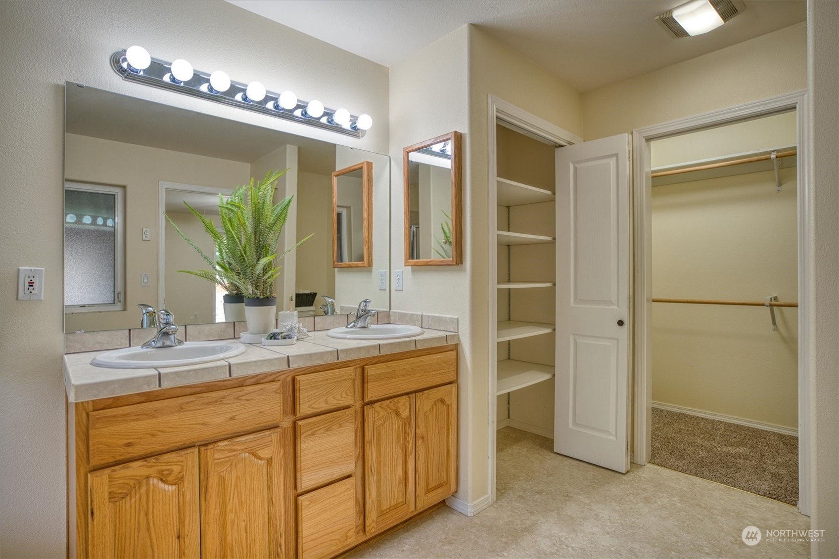 581 Ridge View Drive Sequim, WA 98382 - Photo 20 of 40 a bathroom with a double vanity sink a mirror and a shower