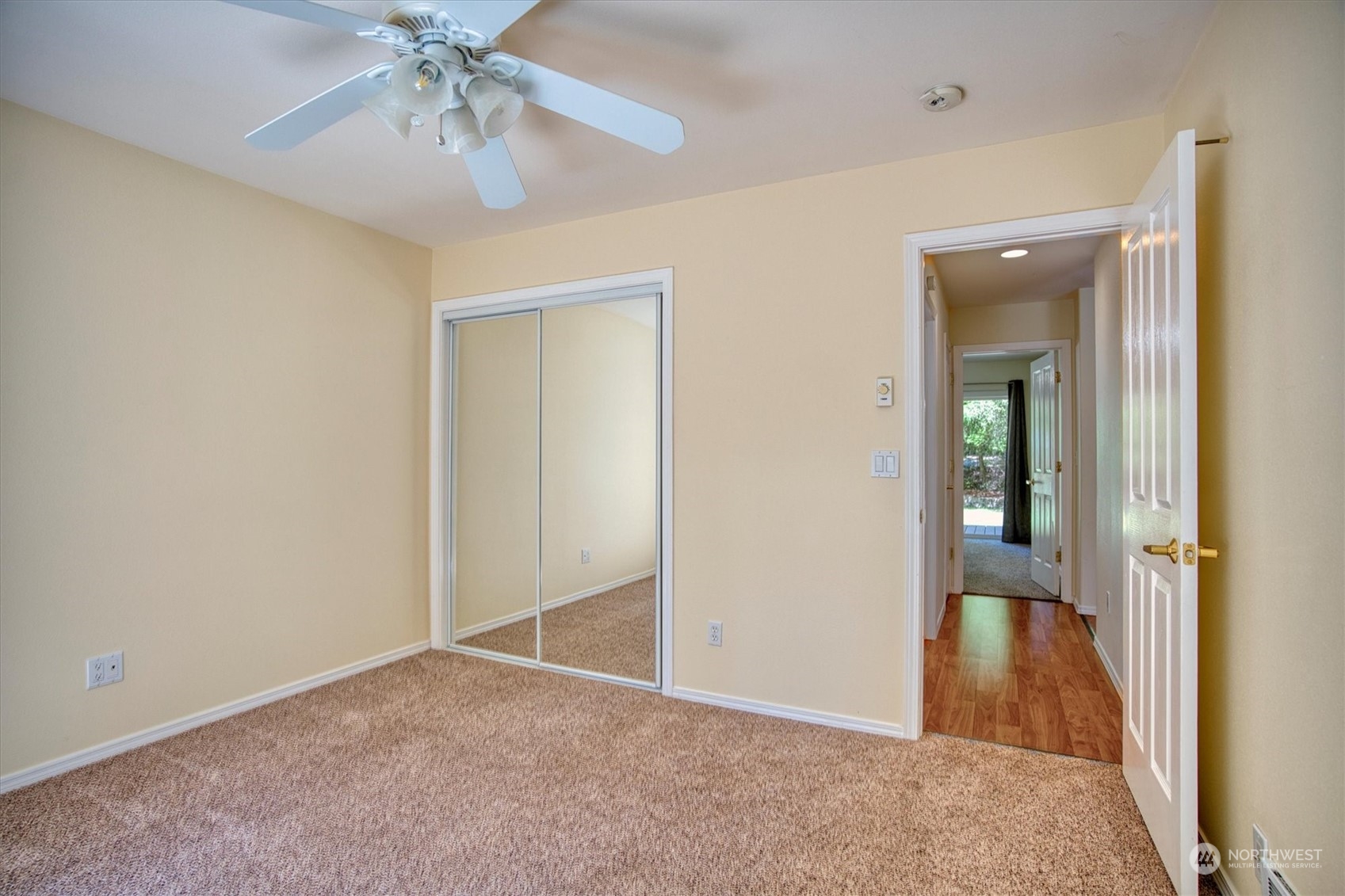 581 Ridge View Drive Sequim, WA 98382 - Photo 24 of 40 an empty room that has a chandelier fan and wooden floor