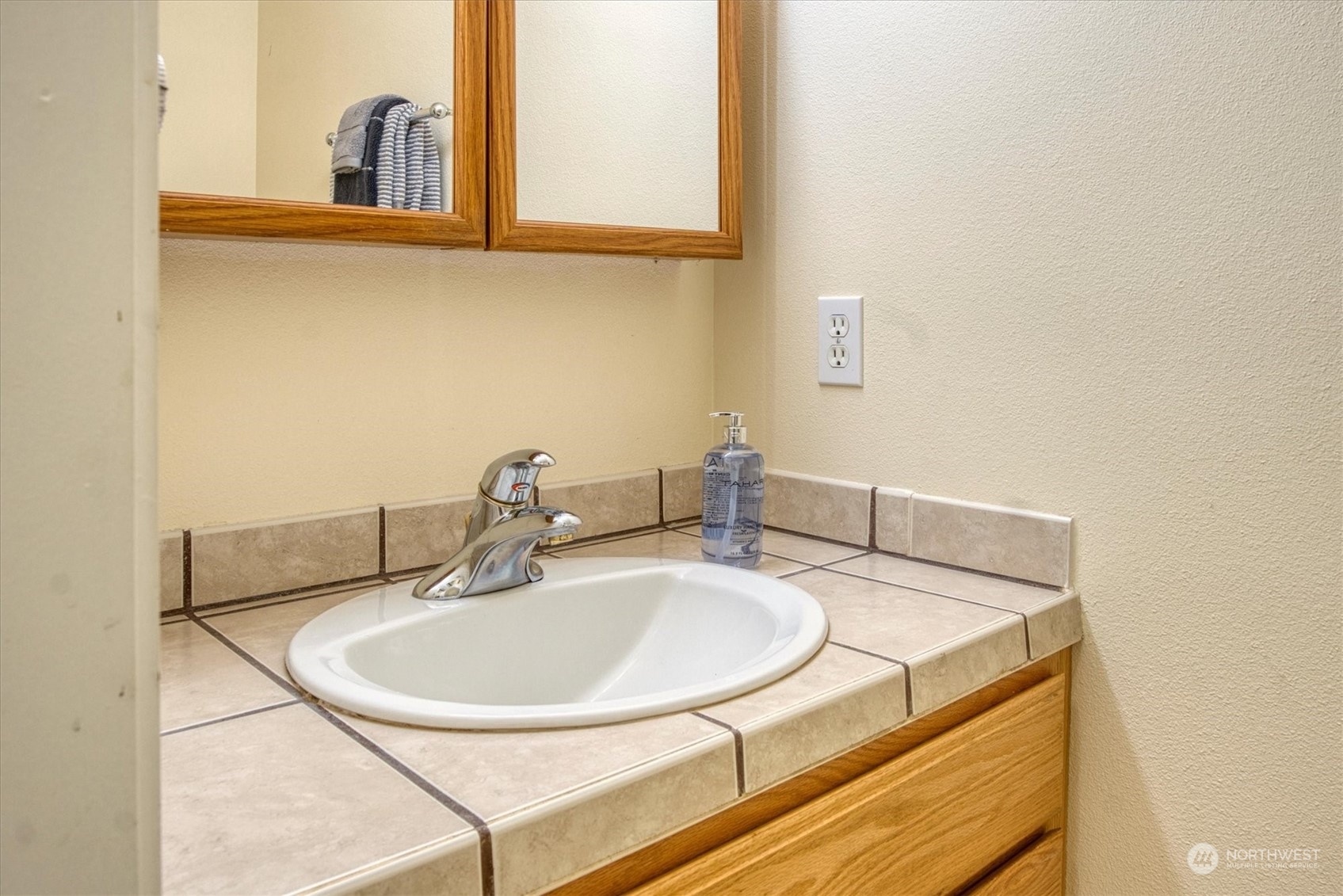 581 Ridge View Drive Sequim, WA 98382 - Photo 30 of 40 a bathroom with a sink and a mirror