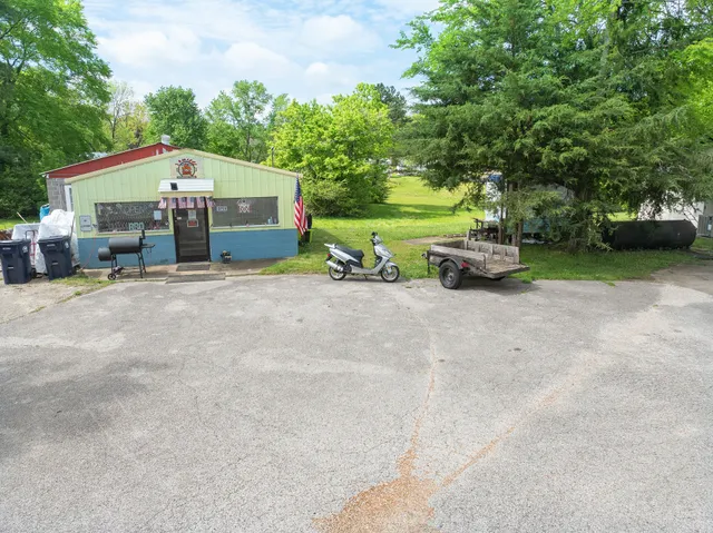 a view of a house with a yard and sitting area