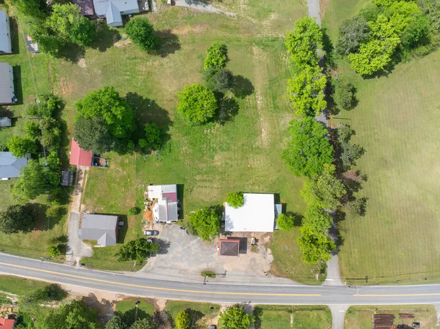 an aerial view of residential house with outdoor space and swimming pool