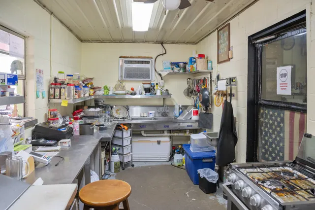 a kitchen with a refrigerator and a stove