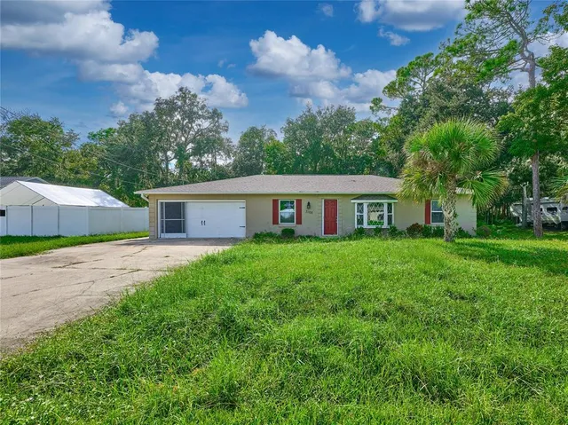 a front view of house with yard and green space