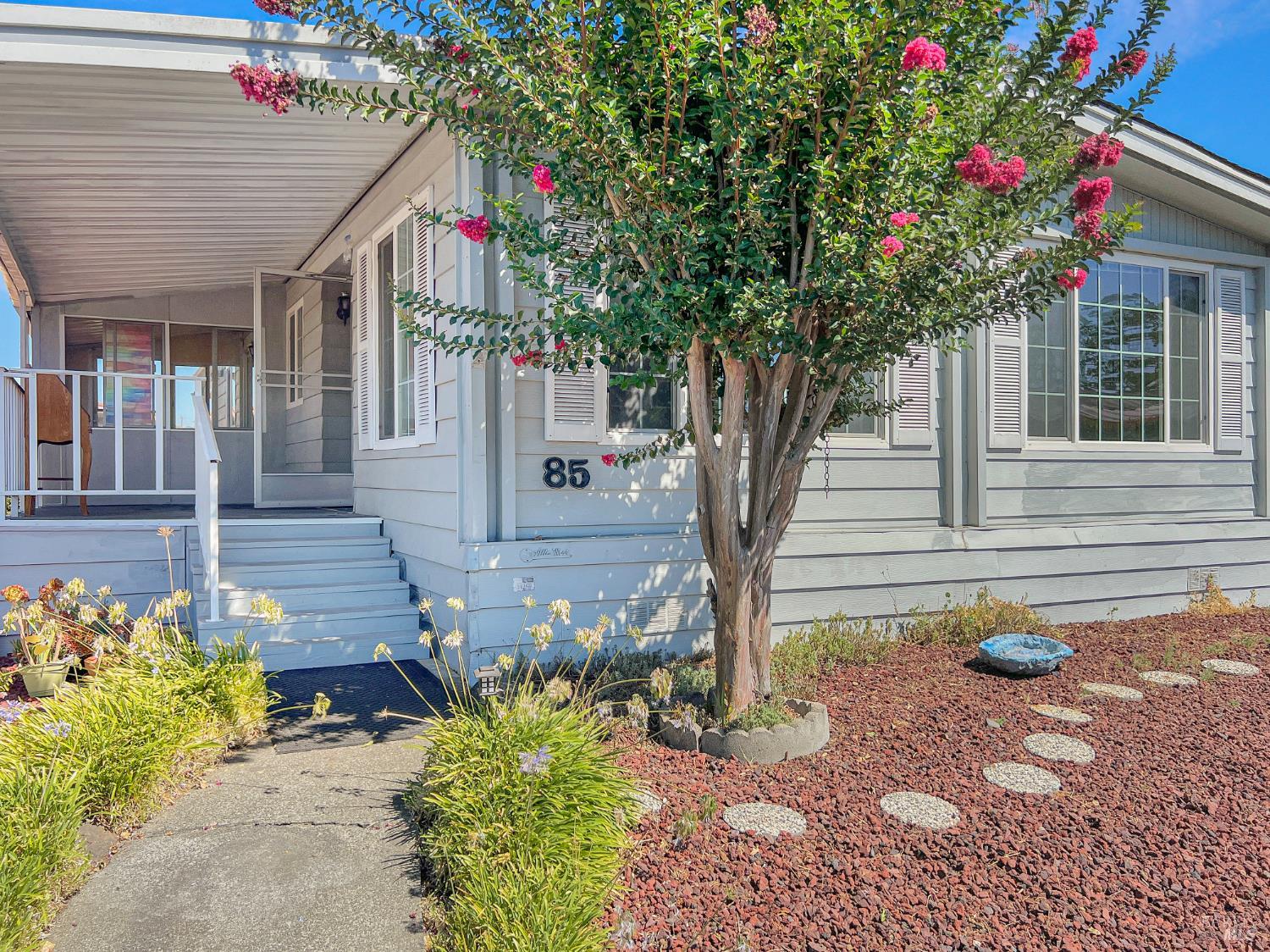 a front view of a house with garden