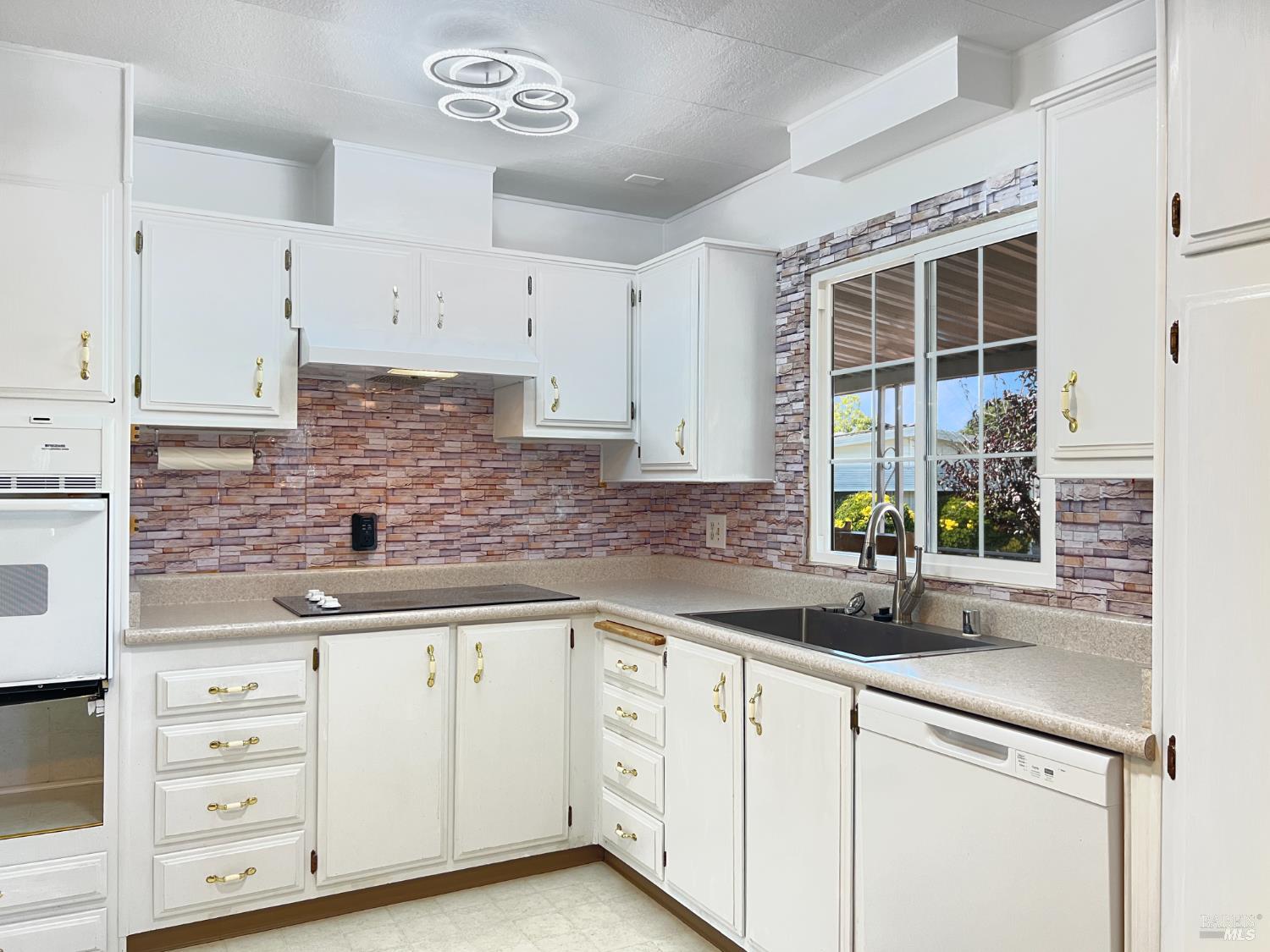 85 Estrella Drive Santa Rosa, CA 95403 - Photo 3 of 27 a kitchen with stainless steel appliances white cabinets and a sink