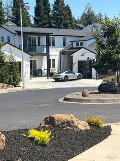a view of a house with pool and sitting area