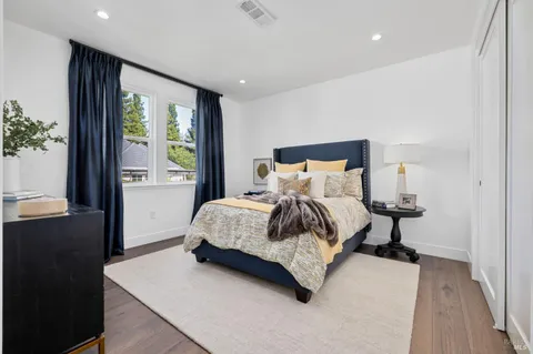 a spacious bedroom with a bed and a window